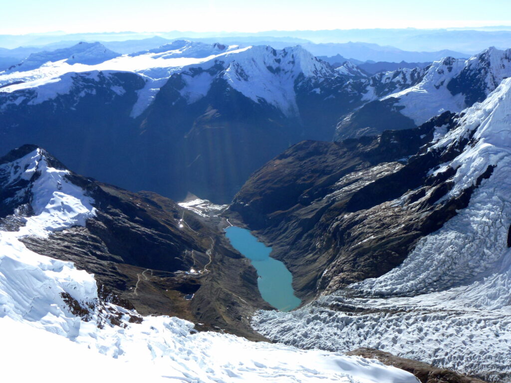 Zdjęcie przedstawia lodowce górskie. W dolinie widać jezioro typu GLOF.
