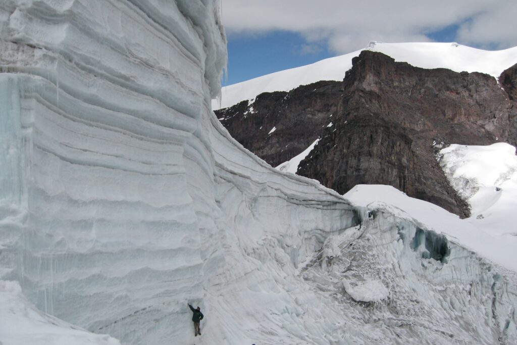 Na zdjęciu widać człowieka na tle lodowców. Widać, że lód składa się z warstw.