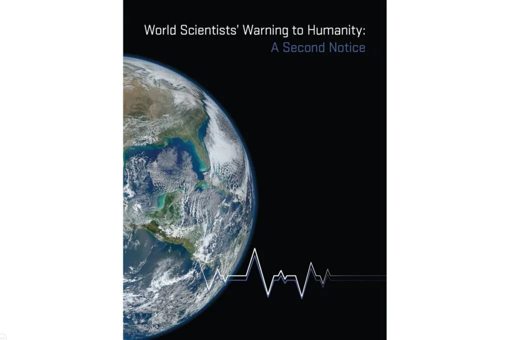 Grafika z okładki pisma Bioscience, kula ziemska widoczna z kosmosu, wykres kojarzący się z elektrokardiogramem, napis „World Scientists’ Warning to Humanity: A Second Notice”